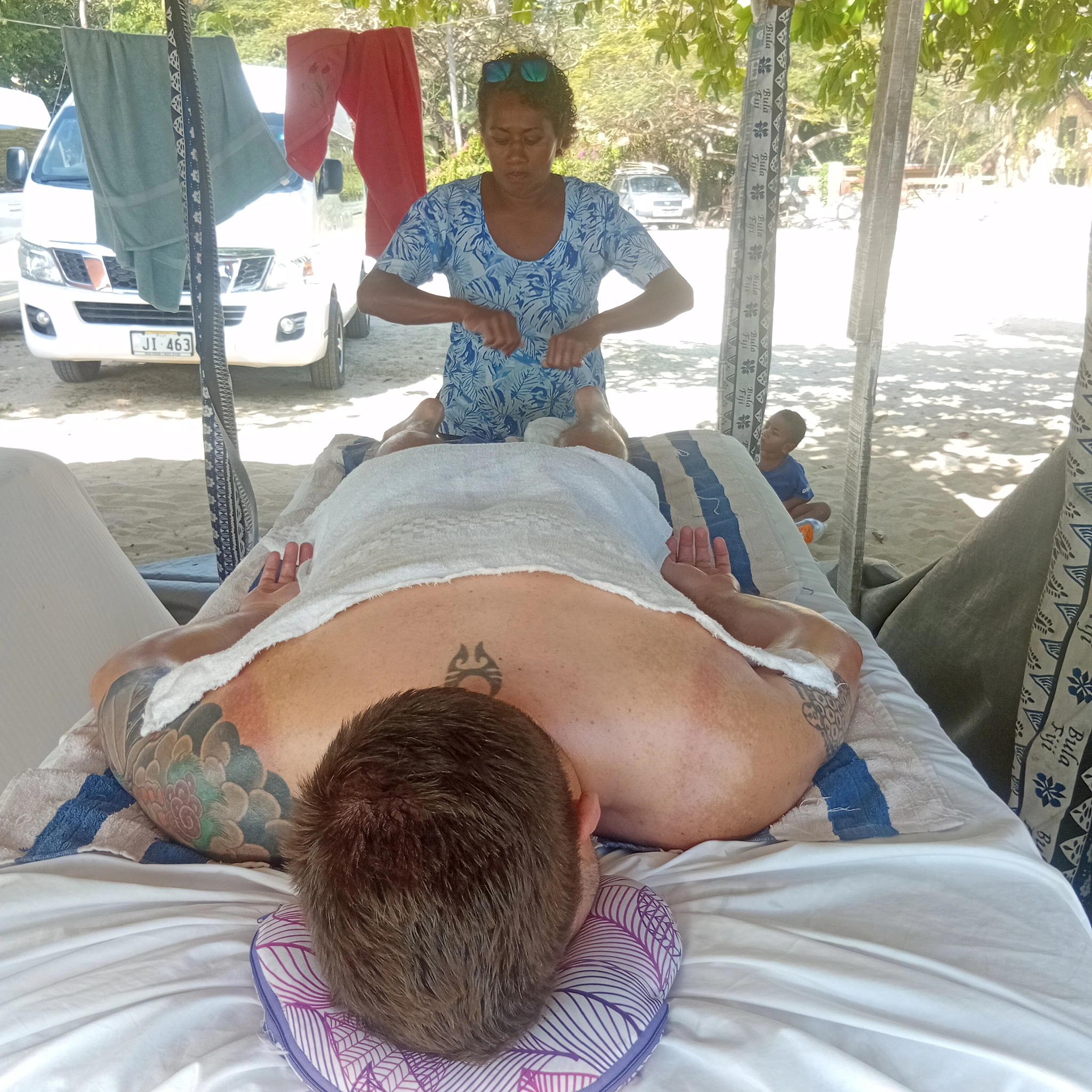 Relaxing massage treatment with tropical flowers